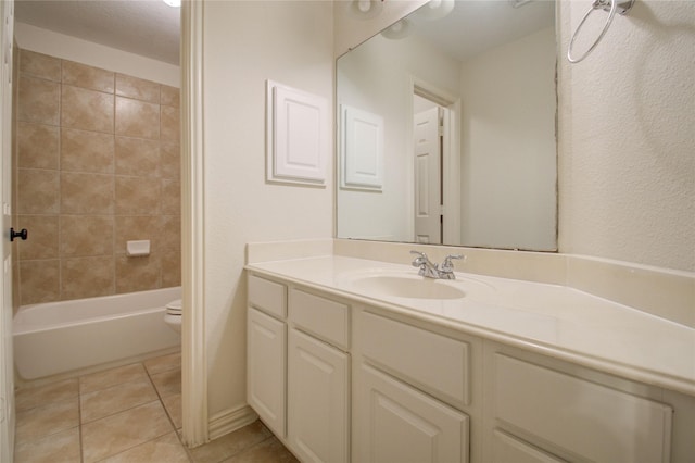 full bathroom featuring toilet, tiled shower / bath combo, tile patterned floors, and vanity