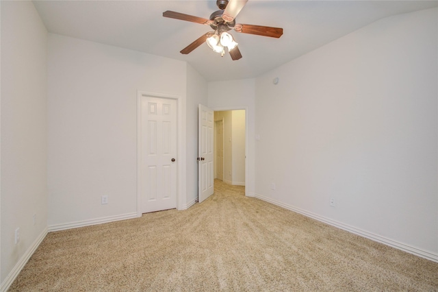 spare room featuring ceiling fan and light colored carpet