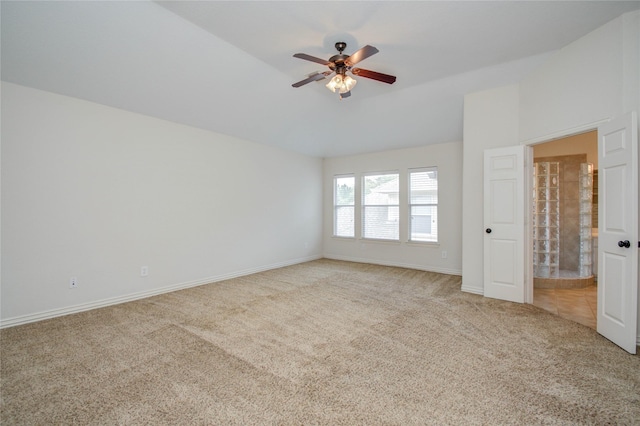 empty room featuring ceiling fan and light colored carpet