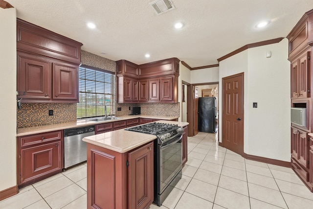 kitchen featuring black appliances, light tile patterned flooring, crown molding, and a kitchen island