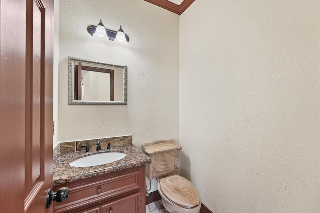 bathroom with toilet and vanity