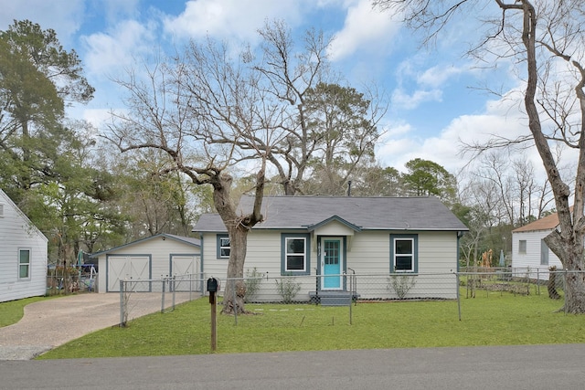 ranch-style home featuring a garage, a front yard, and an outbuilding