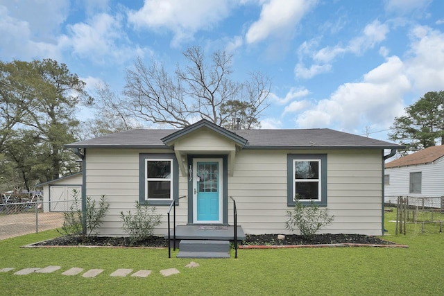 bungalow-style home featuring a front lawn