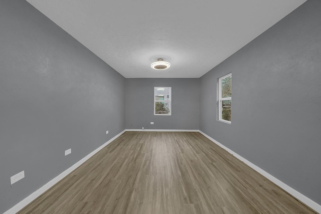 spare room with hardwood / wood-style floors and a textured ceiling