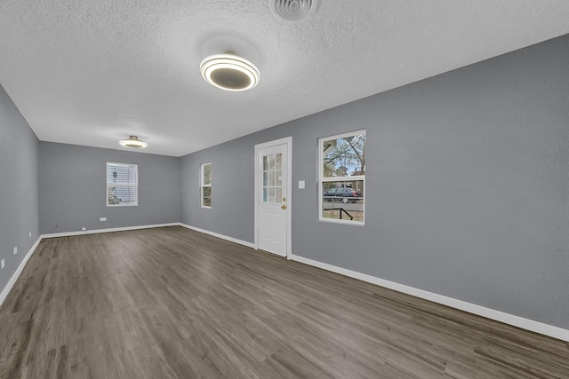 interior space with wood-type flooring and a textured ceiling