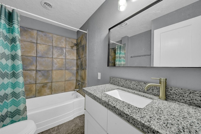 full bathroom featuring toilet, shower / tub combo with curtain, tile patterned floors, a textured ceiling, and vanity