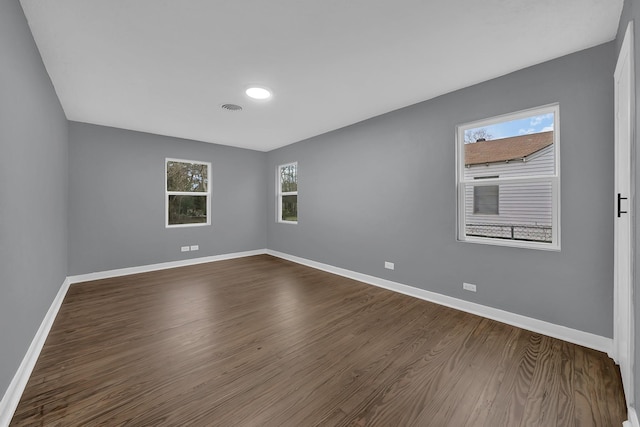 unfurnished room featuring dark wood-type flooring