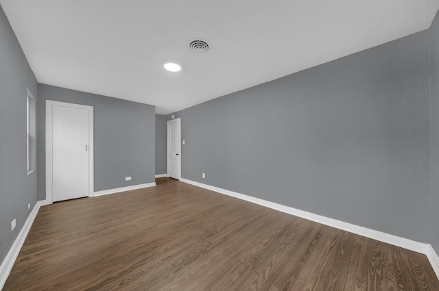 spare room with dark hardwood / wood-style floors