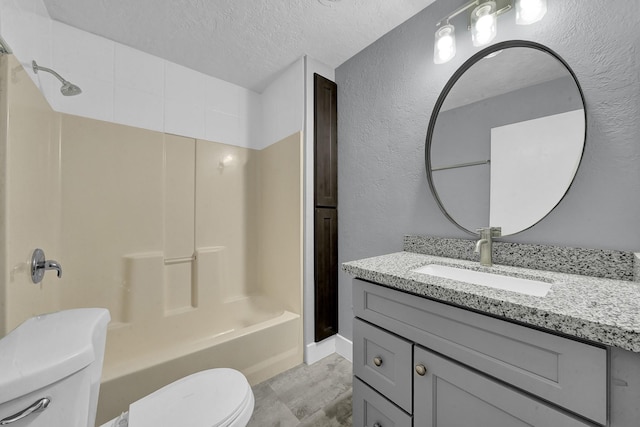 full bathroom with a textured ceiling, toilet, shower / washtub combination, and vanity