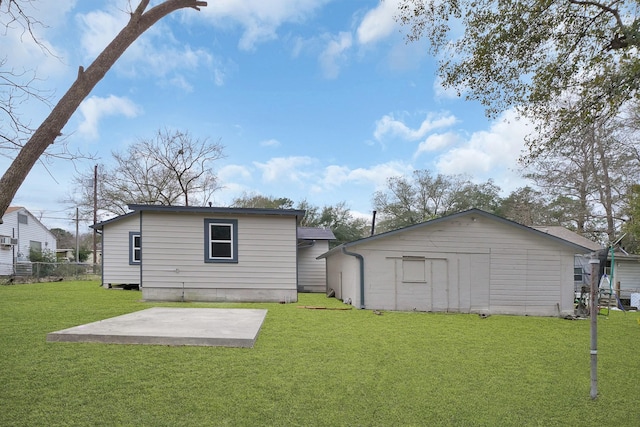 back of house featuring a yard and a patio