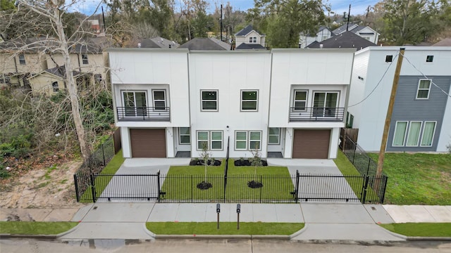 view of front of property with a front lawn, a garage, and a balcony