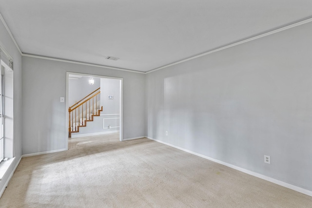 carpeted spare room featuring ornamental molding