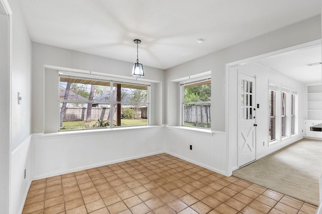 unfurnished dining area featuring light tile patterned flooring