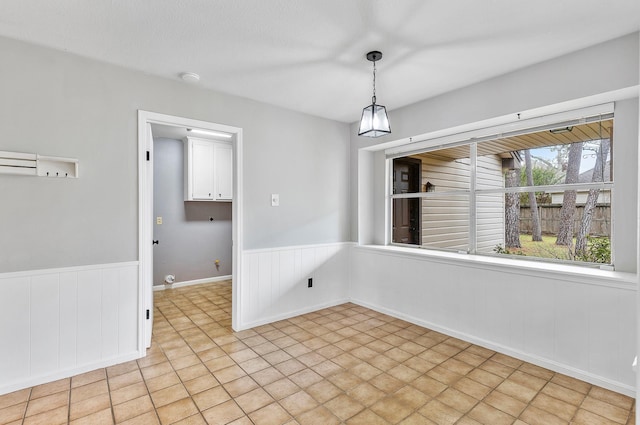 unfurnished dining area featuring light tile patterned floors