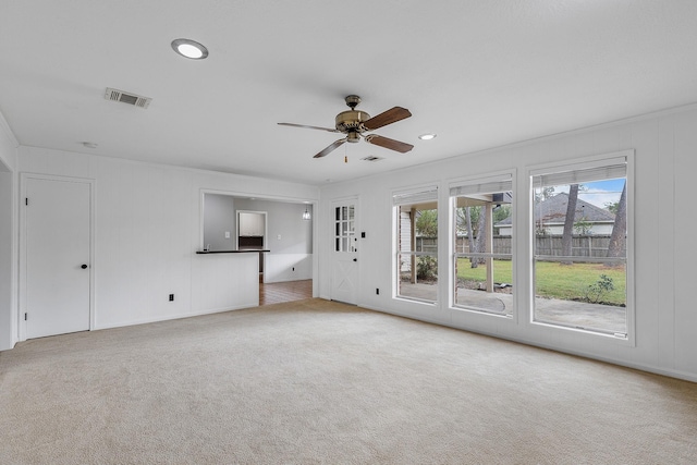 unfurnished living room with ceiling fan and light carpet