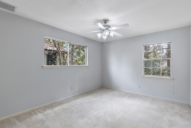 carpeted empty room with ceiling fan