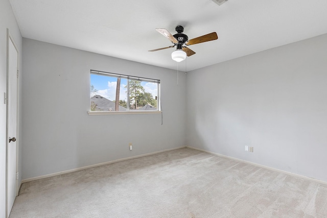 spare room featuring ceiling fan and light colored carpet