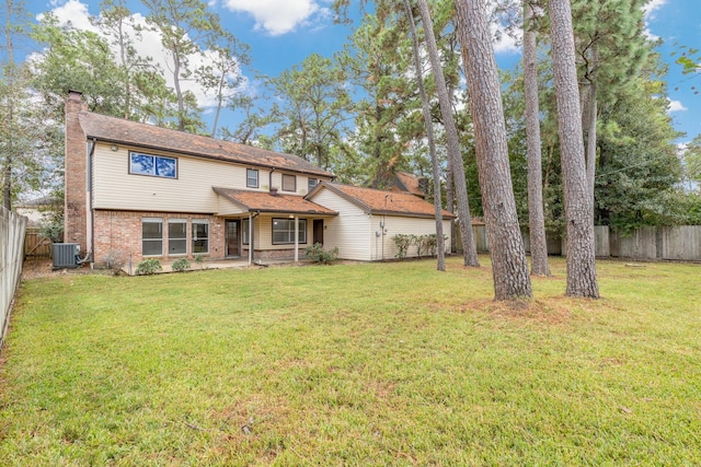 view of property with a front yard and central air condition unit