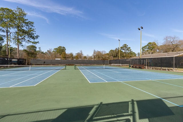 view of tennis court featuring basketball court