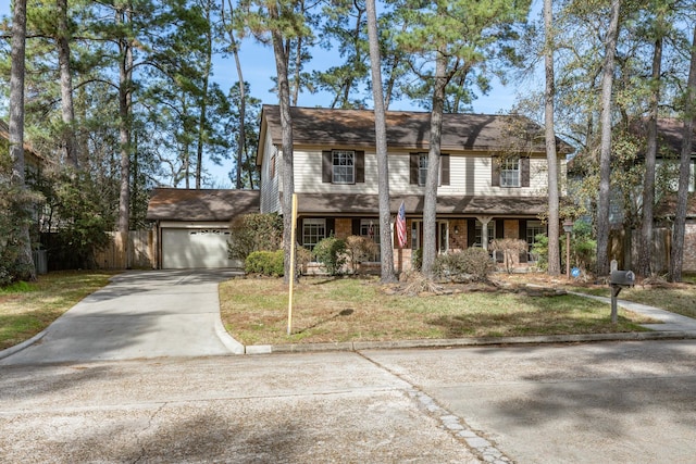 view of front of home with a garage, a front yard, and a porch