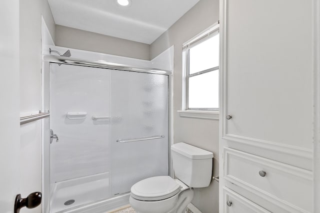 bathroom with toilet and an enclosed shower