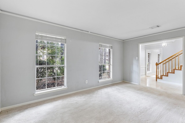 spare room featuring light colored carpet and ornamental molding