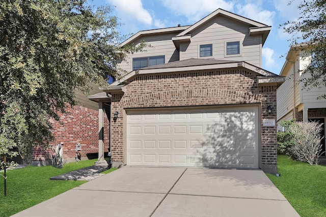 view of front of property with a garage and a front lawn