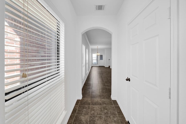 hallway featuring a notable chandelier