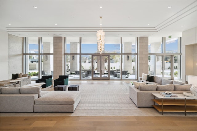 living area with french doors, a wall of windows, plenty of natural light, and light wood-style floors