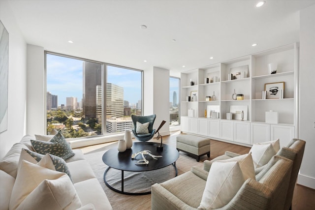 living room featuring a view of city, light wood finished floors, and recessed lighting