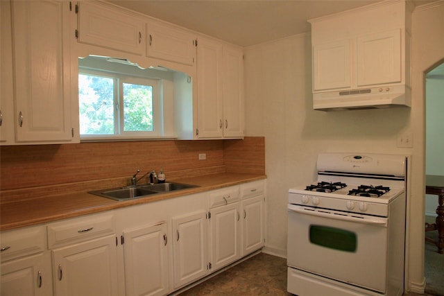 kitchen featuring white cabinets, gas range gas stove, backsplash, and sink