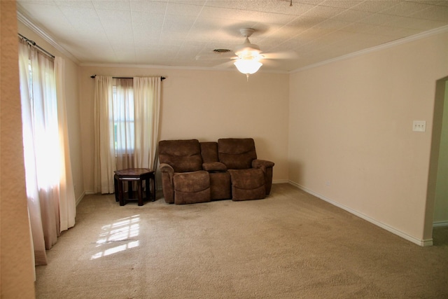 living room featuring ceiling fan, ornamental molding, and light colored carpet