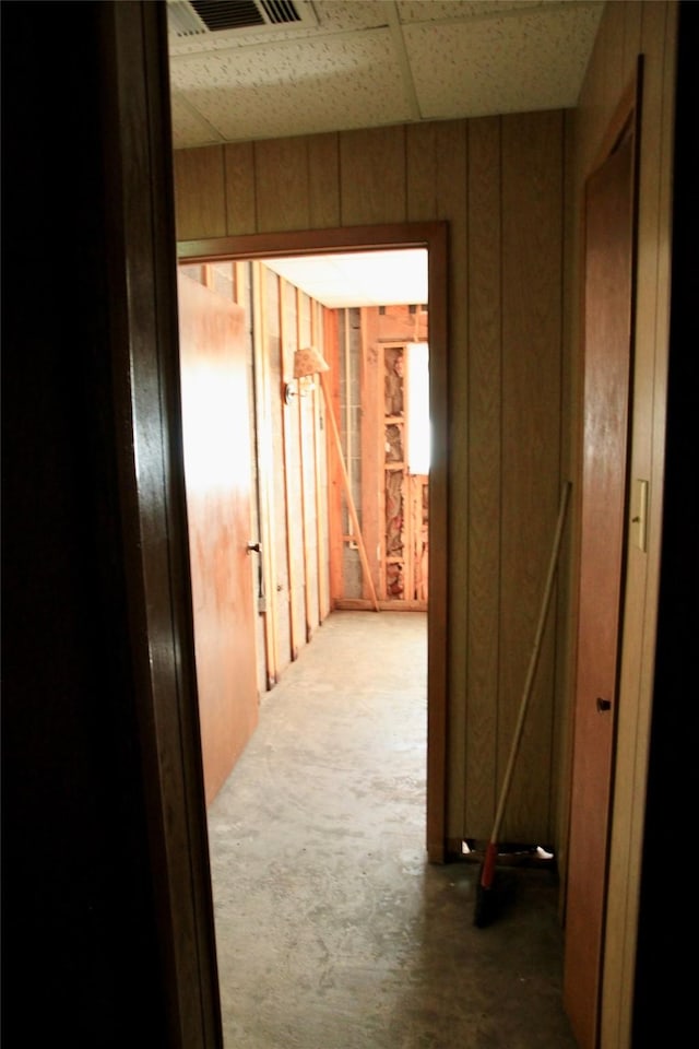 hallway featuring a paneled ceiling