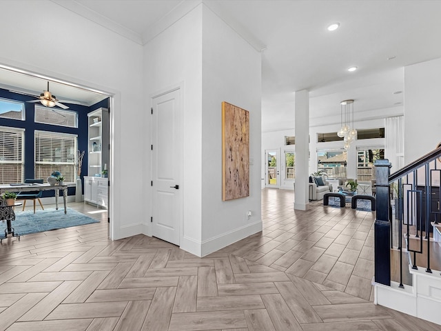 hall with french doors, ornamental molding, and light parquet flooring