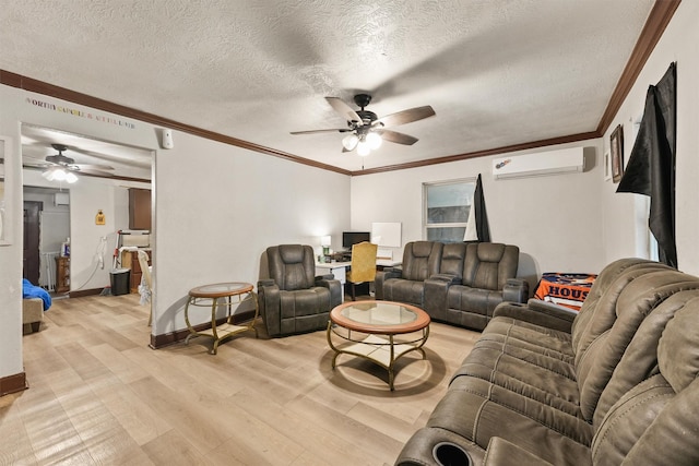 living room with light wood-type flooring, crown molding, a textured ceiling, and a wall mounted air conditioner