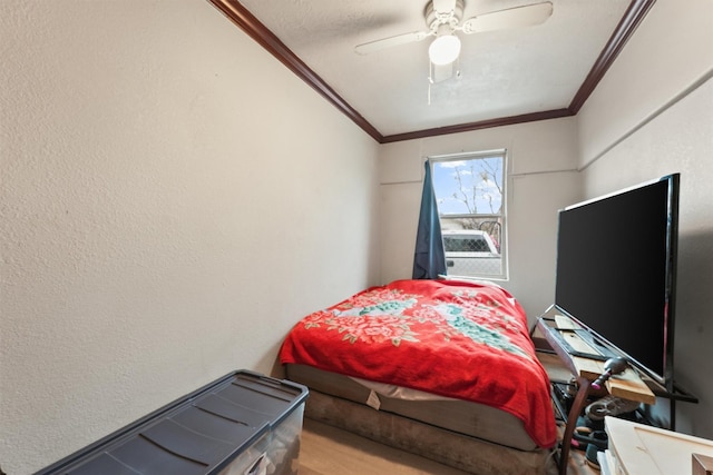 bedroom with ceiling fan, a textured ceiling, and crown molding