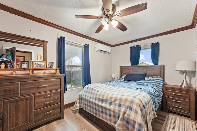 bedroom with a wall unit AC, ceiling fan, light wood-type flooring, a textured ceiling, and crown molding