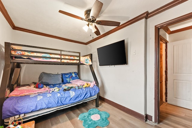 bedroom with ceiling fan, crown molding, and light hardwood / wood-style floors