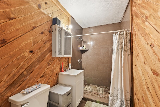 bathroom featuring sink, wooden walls, a textured ceiling, and curtained shower