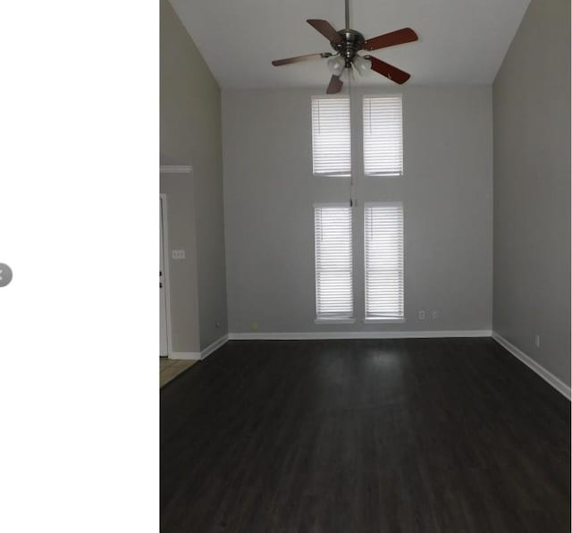 unfurnished room featuring ceiling fan and dark wood-type flooring