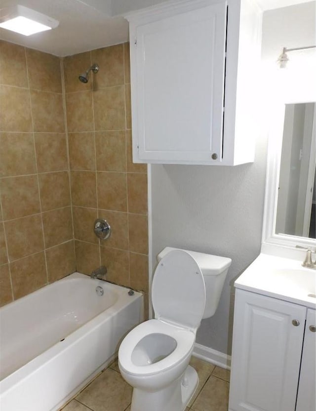 full bathroom featuring toilet, tiled shower / bath, tile patterned flooring, and vanity