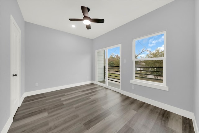 spare room with ceiling fan and dark wood-type flooring