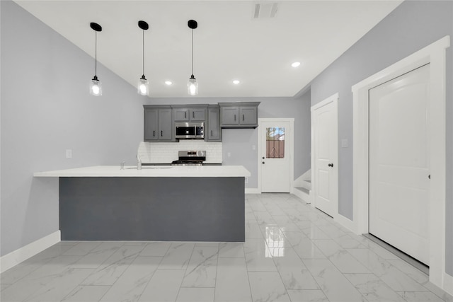 kitchen featuring gray cabinets, stainless steel appliances, backsplash, pendant lighting, and sink