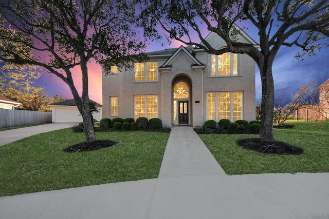 view of front of house with a garage and a yard