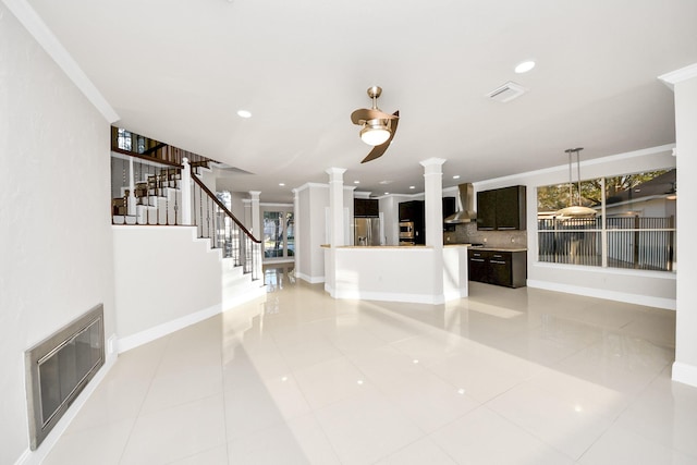 unfurnished living room featuring light tile patterned floors, crown molding, and decorative columns