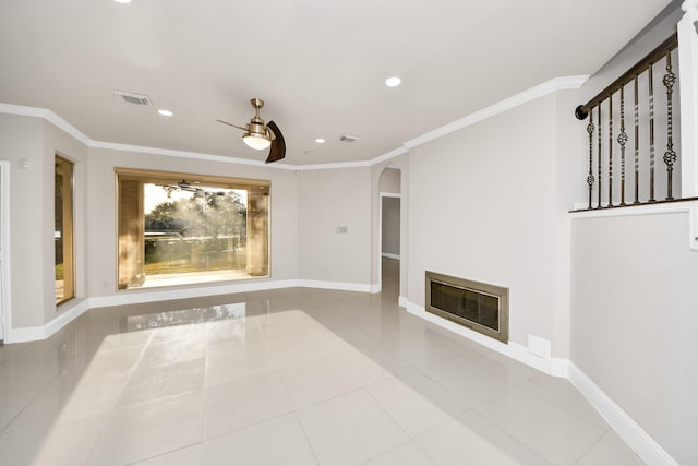 unfurnished living room with ceiling fan, tile patterned floors, heating unit, and ornamental molding