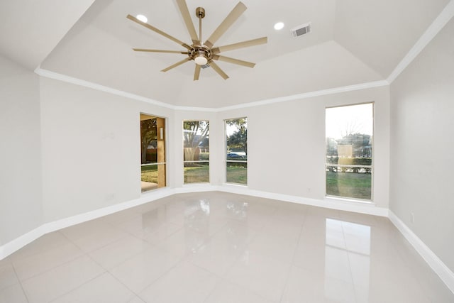 tiled spare room featuring ceiling fan, a tray ceiling, crown molding, and a healthy amount of sunlight