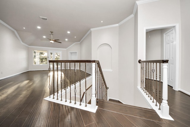 staircase featuring lofted ceiling, ceiling fan, crown molding, and wood-type flooring