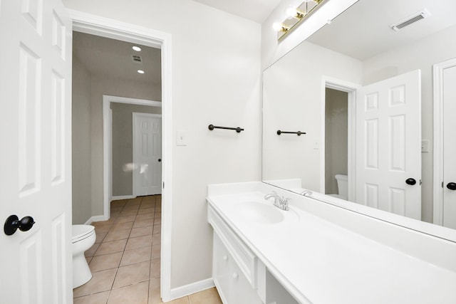 bathroom featuring toilet, tile patterned floors, and vanity