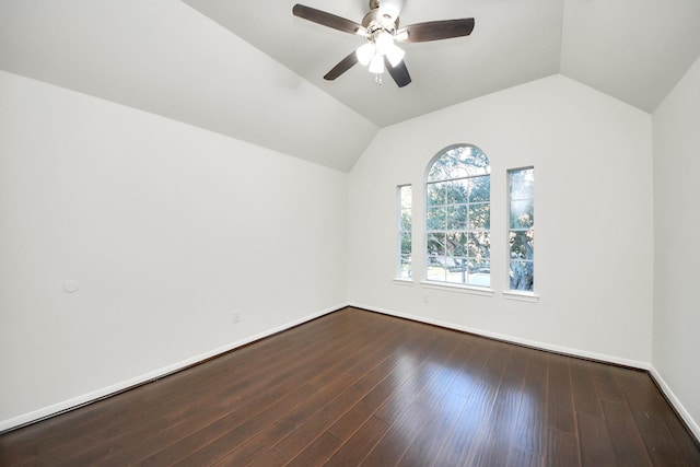 spare room with lofted ceiling, ceiling fan, and dark wood-type flooring